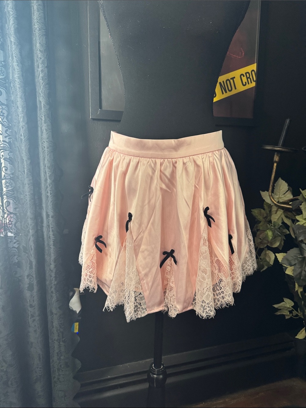 Sugar Thrillz Light Pink Satin Skirt with Black Bow Accent